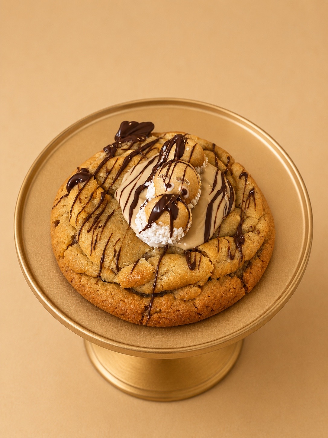Stuffed cookie drizzled with chocolate on a gold cake stand